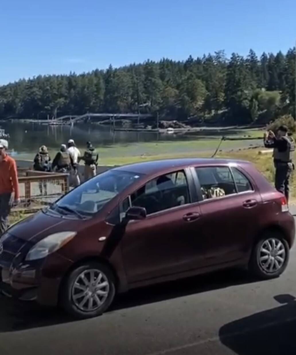 Screenshot from a video provided by Leo Baker as Guilherme Silva was taken onto a boat for transfer. An ICE agent can be seen snapping photos of the marina view behind him.
