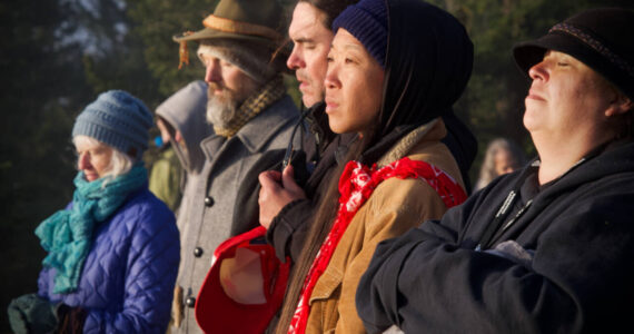 Darrell Kirk photo. 
Jasmine Ikeda (far right) on top of Mt. Constitution during the Sacred Sunrise Ceremony, which took place during the Gathering of the Eagles Canoe Voyage, which landed on Olga this spring.
