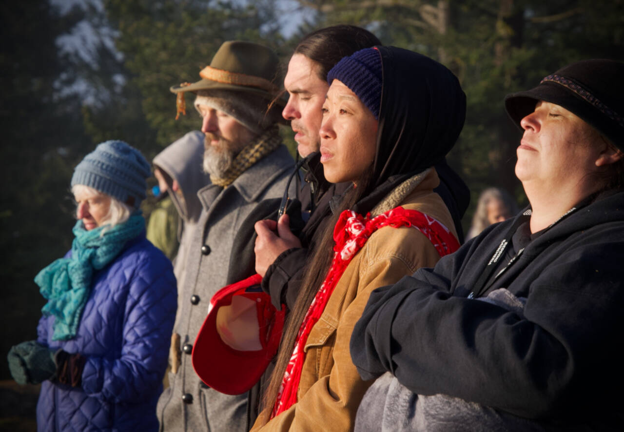 Darrell Kirk photo. 
Jasmine Ikeda (far right) on top of Mt. Constitution during the Sacred Sunrise Ceremony, which took place during the Gathering of the Eagles Canoe Voyage, which landed on Olga this spring.