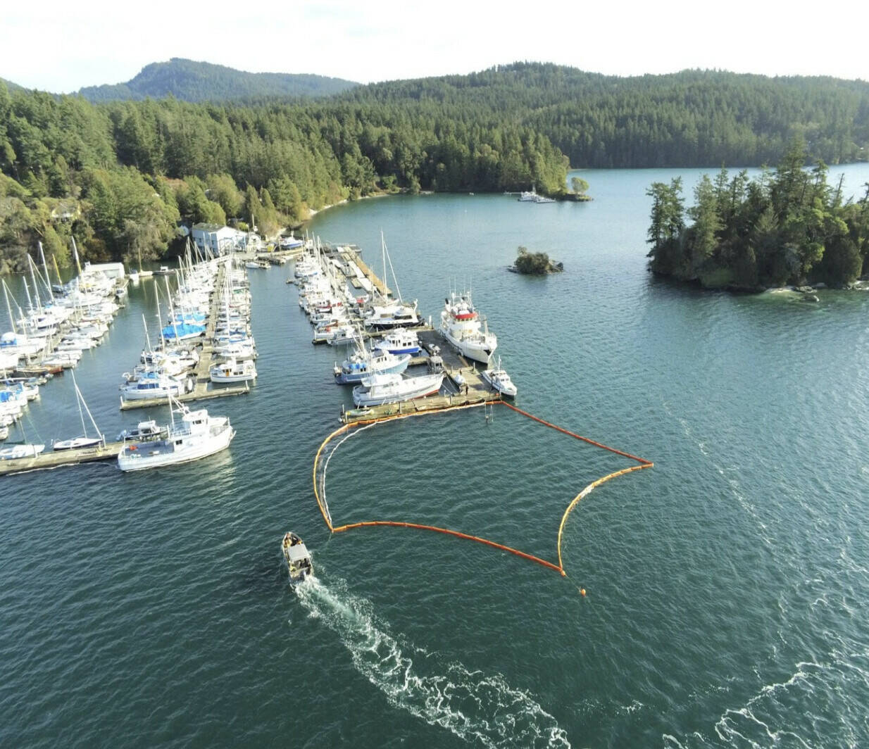 Contributed photo.
Nov. 18, 2023: The former Army tug El Capitan sank at its moorings in West Sound. Previous work on this abandoned vessel had removed most of the fuel, but there were still caches of petroleum products aboard that leaked into the Sound. IOSA responded immediately by providing on-site information to the USCG and other agencies and surrounded the sunken vessel with containment boom within a few hours of the sinking. The IOSA boom remained in place until the vessel was raised and salvaged seven months later.