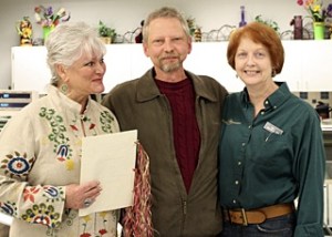 Rev. Shawn Shelton (l) performed vow renewals for Kirk and Denise Troutman last week in Island Market. The ceremony was a complete surprise to Denise.