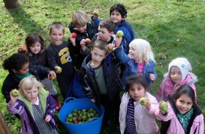 Orcas Montessori School kids show off their haul of organic apples.