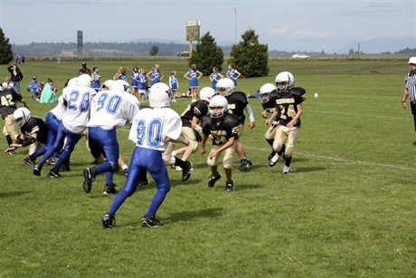 The Kings thwart the oncoming defense and protect their ball-carrier in the season kick-off jamboree.