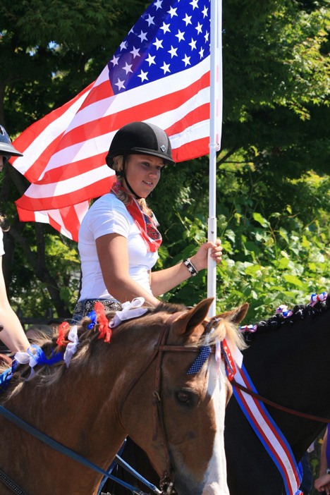 Daria Stankevich rides in the parade.