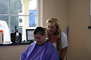 Melissa Lowry etching “Jordan” into Chris Hamilton’s hair.