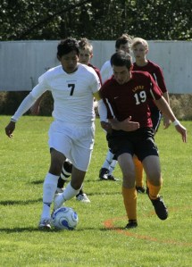 Viking Fernando Alevaro and Lobo Tahoma Wrubleski scramble for ownership of the ball at Saturday's soccer match on Orcas Island.