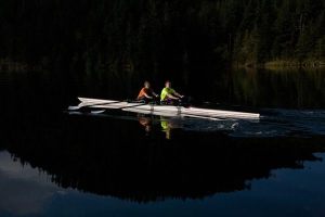 Max Blackadar and Josh Bronn rowing across the mirror-like surface of Cascade Lake. Orcas Island Rowing Club’s fall rowing season begins on Saturday