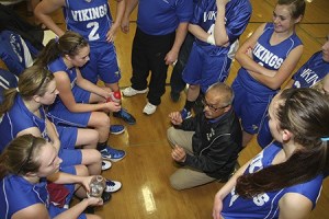 Left: Coach Gregg Sasan talks to the Lady Vikings at the Friday Harbor game. It was a tough battle with Orcas winning