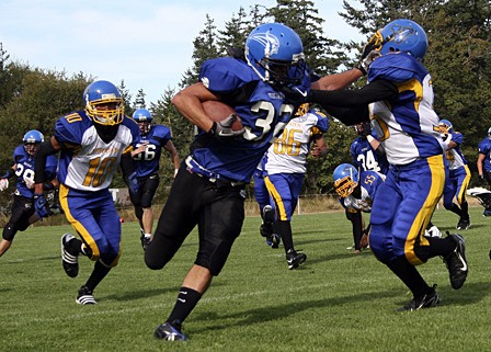 Mike Langworthy fends off a Pirates player during the game against Arizona’s Valley High School.