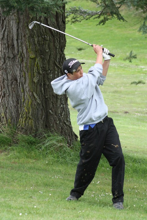 Orcas player Miles McCloskey raises a spray of turf with a hard drive.