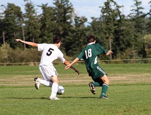 Viking Christopher Ghazel competes for possession  against a Cedar Park Christian player.