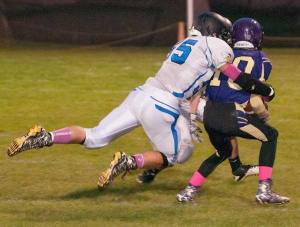 Viking Kyle Masters sacks the Friday Harbor quarterback. Viking Haley Moss (left) goes for the ball against Mt. Vernon.