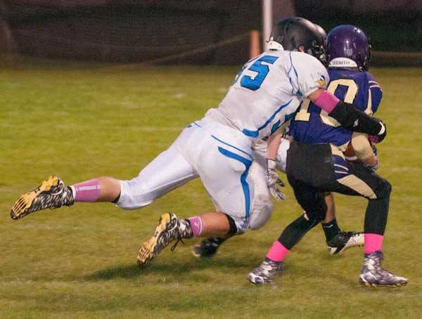 Viking Kyle Masters sacks the Friday Harbor quarterback. Viking Haley Moss (left) goes for the ball against Mt. Vernon.