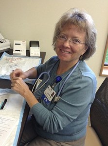 Nurse and diabetes educator Joann Mayo prepares to test the blood-glucose level of a participant in a state-funded free diabetes class