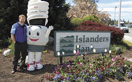 Tony Fyrqvist of Islanders Bank with CFL Charlie in Friday Harbor to promote energy efficiency.”