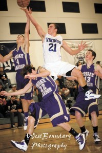 Viking Aubrey Schermerhorn drives between Wolverine defenders.