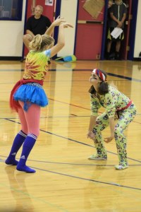 Two freshman play the bear-gorilla-duck game at the assembly.