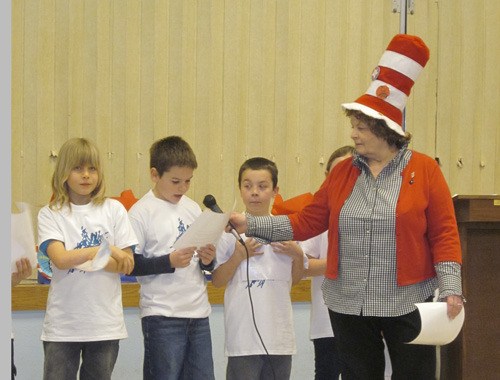 Third graders reading during the assembly for Read Across America Day on Friday