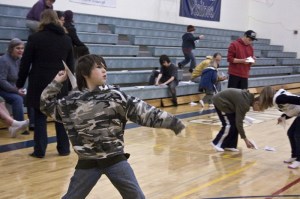 A youth practicing for the 17th annual Kiwanis paper airplane contest