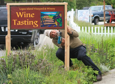 Brent Charnley putting up the sign for the new tasting room.