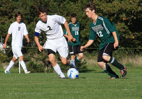 Rhys Thompson is challenged by a Shoreline player.