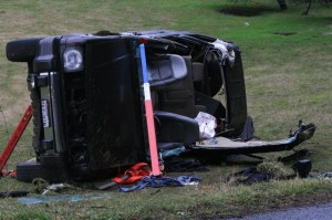 The van rolled over after being struck by the sedan.