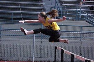 Lopez team member clears the hurdle.