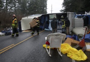 Orcas Fire and Rescue move household items from a turned over Atlas moving van.