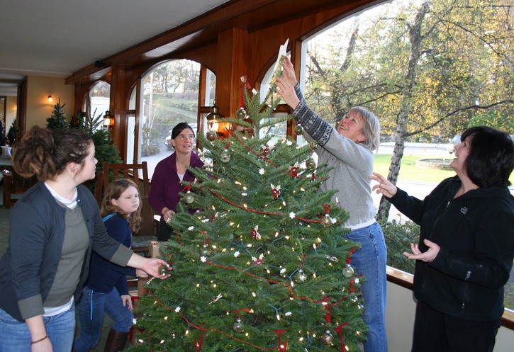 The photo is volunteers for 'Friends of Moran' decorating their tree in the Rosario Lobby.