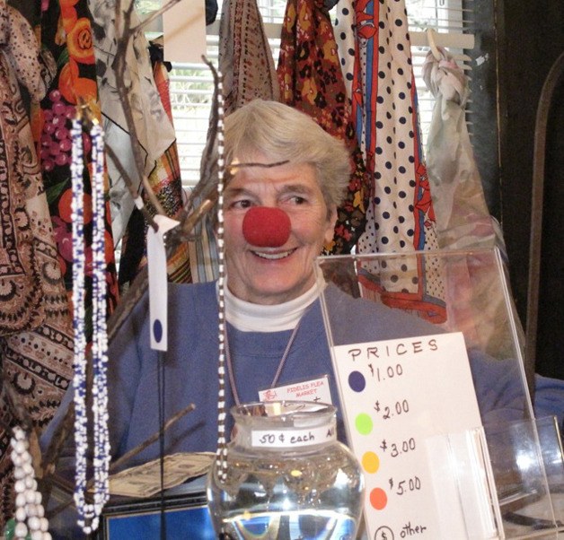 Margot Shaw staffs a table at last year's Fidelis Flea Market.