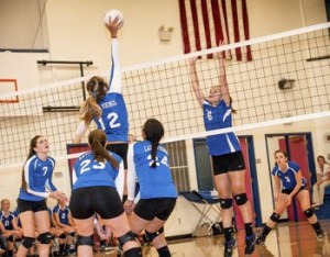 Mary Wilson (12) taps the ball over for scoring a point for the Lady Vikings.