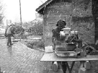 Volunteers Michael Budnick and Laura Gibbons complete the Orcas Island Historical Museum’s name-engraved brick path to the new museum entrance – in the heart of the sudden heavy snowfall on April 18.