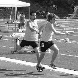 Jordan Smith hands baton to Sebastian Lasbo for the final leg of the 4 x 400m relay. The Lobos won the event to qualify for the State Championship Meet.