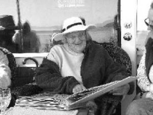Barbara Meyer enjoys a birthday scrapbook at her 90th birthday celebration May 27. The highlight of the event was a surprise gift of the scrapbook of creative birthday wishes from Barbara’s friends on and off the island