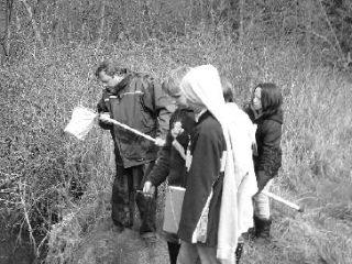 Marilyn Storey’s fifth grade class out working with the San Juan Nature Institute. In the photo: Scientist Russel Barsh with students Nate Lawson