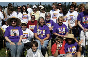 Cancer survivors in the dark shirts are ready to walk the first lap. Center