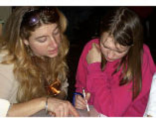 Darlene helping a student at the Funhouse’s Homework Club.