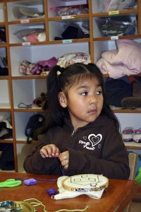 Lupita Alcaraz working on a sewing project at Orcas Montessori.