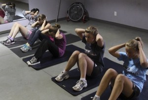 The seventh and eighth grade OCS girls working out at the gym.