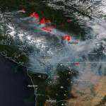 Satellite photograph of southern British Columbia and Washington state on Wednesday, August 1, 2017, showing smoke from the BC fires streaming through the Fraser River gap toward the San Juans and Canadian Gulf Islands.