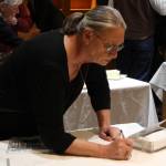 Staff photo/Hayley Day                                Party attendees write greetings to the retiring judge.