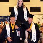 Salutatorians Vanya Bullock (left) and Hayden Simpson (right) carrying classmate Katelyn Minnis.
