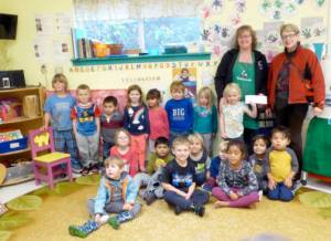 Kaleidoscope Preschool Director Amber Paulsen and Kaleidoscope kids receive $750 from Secretary of the Emmanuel Parish St. Agnes Guild, Joanne Cundy.