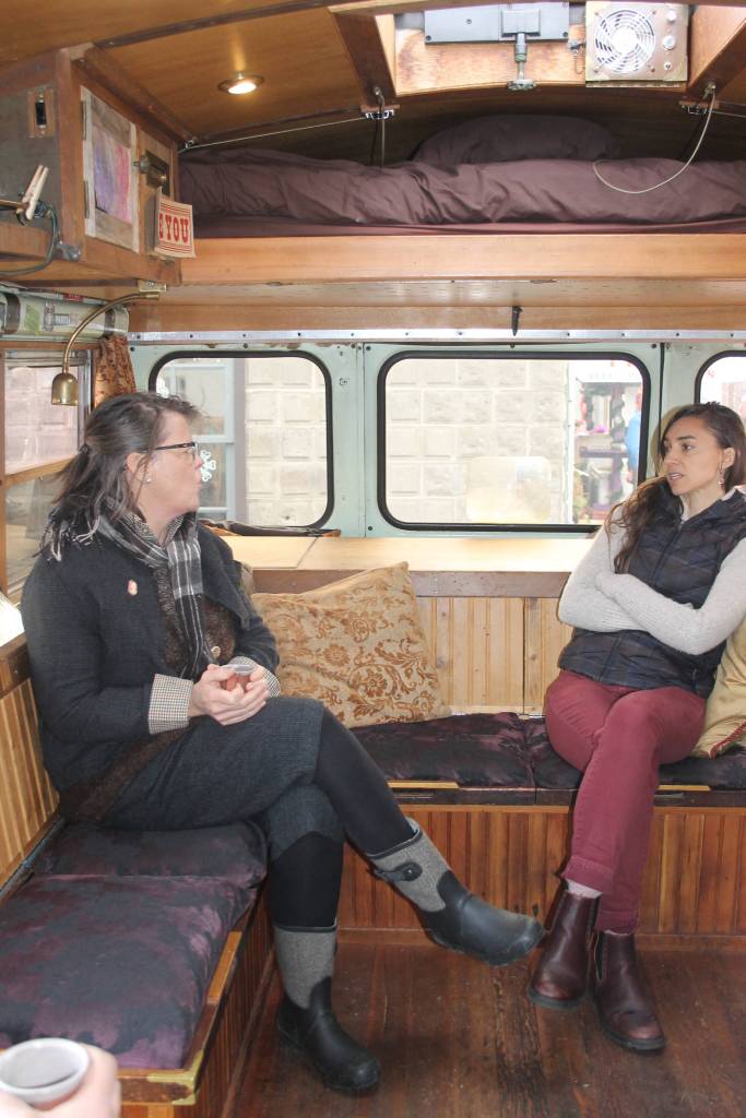 Staff photo/Heather Spaulding. Inside the bus Ally Rugge engages with the public.