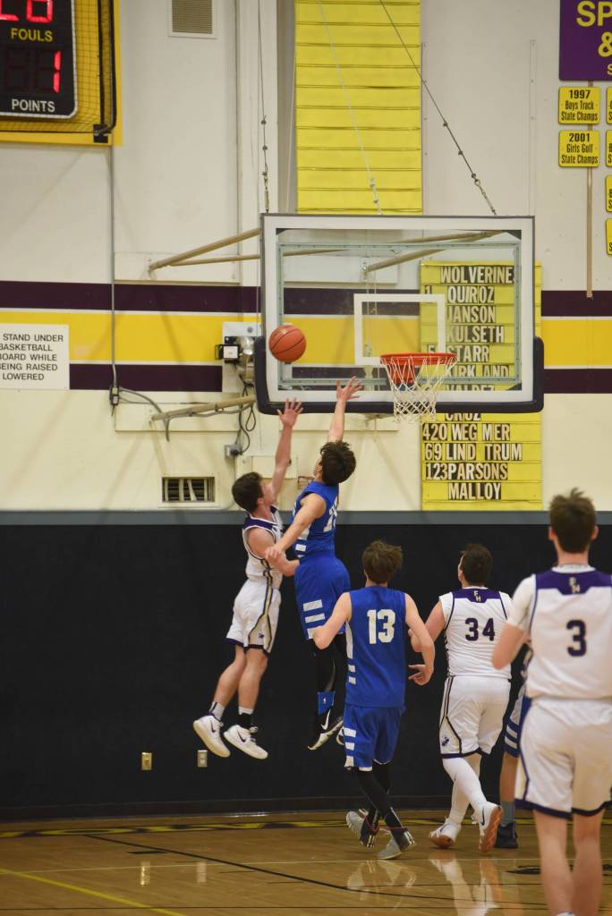 Staff photo/Tate Thomson                                Ethan Germain shoots against heavy defense.
