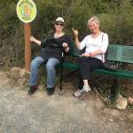 Contributed photo                                Graphic Artist Ginna Magee, designer of the Ride Share sign, and Sheila Gaquin practice hitching a ride.