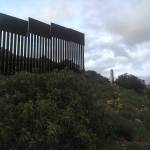 Border marking post next to border wall. Here Paul Pineda in on the Mexico side facing north