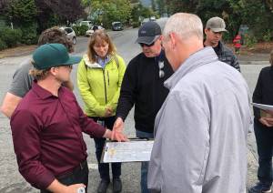 Contributed photo                                Councilman Rick Hughes (black jacket) and Rep. Rick Larsen (gray jacket) discuss Prune Alley.