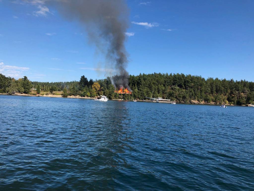 Contributed photo                                A Deer Harbor neighbor quickly takes a photo of the house fire located on 6300 block of Deer Harbor Road