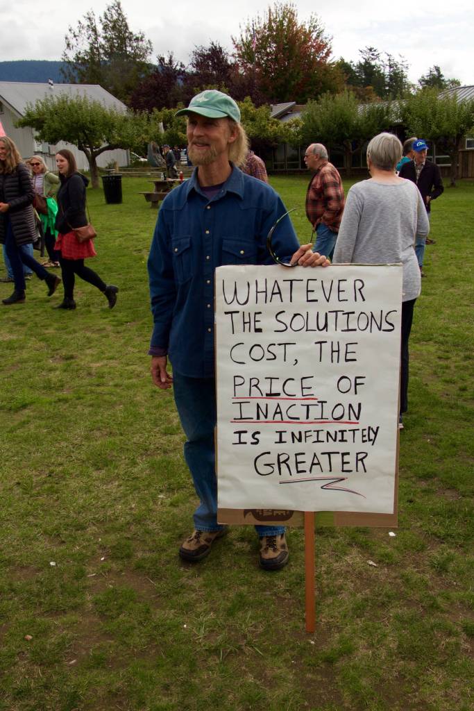 The back of this sign read, Your house is on fire. Wake up! Act accordingly.